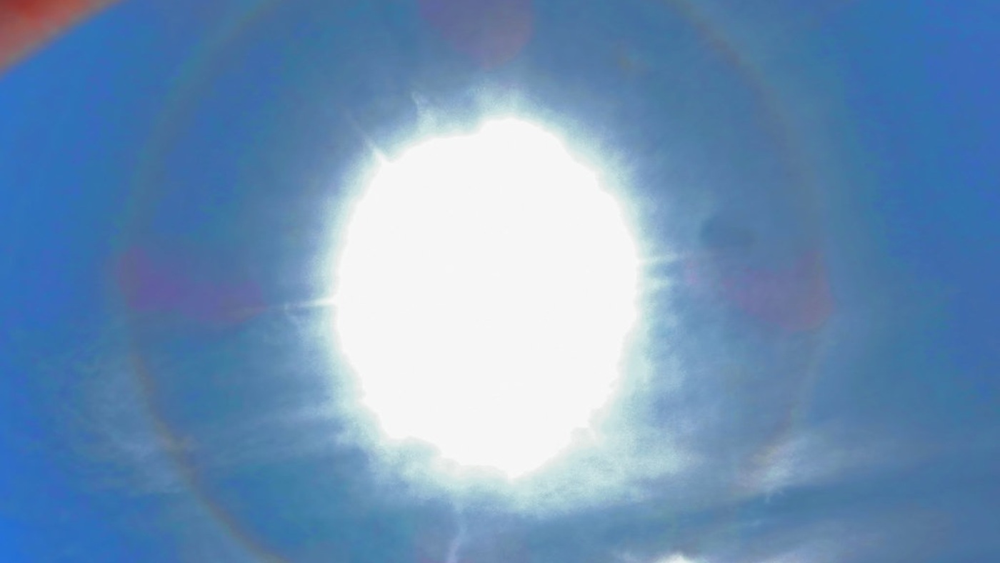 A real halo around the sun. An optical metaphor for probing a judge from different directions, not an evaluation measurement.